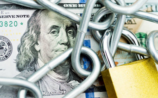 istock One hundred dollar bill with a chain and lock 1094807040