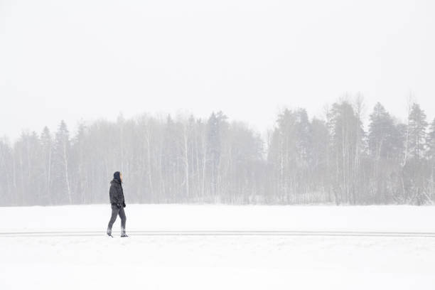 Free Stock Photo of Man Walking Down Snow Covered Road | Download Free ...