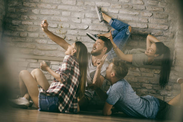 istock Group of playful friends having fun while taking a selfie with smart phone. 1094810524