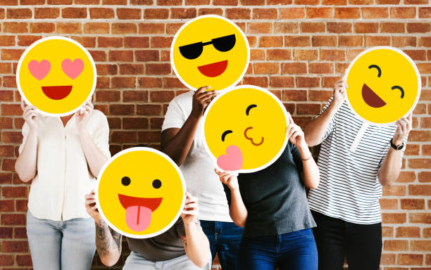 People holding positive emoticons People holding positive emoticons human head photos stock pictures, royalty-free photos & images