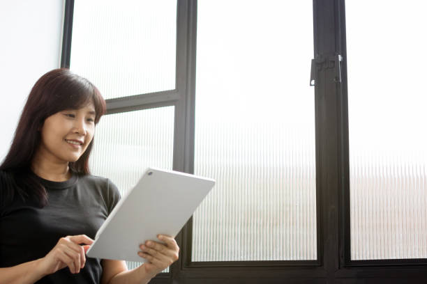 istock Woman holding new version digital tablet device in hands with smart pencil. Tablet and digital pen connecting wifi. Copy space. - Image. 1094813950