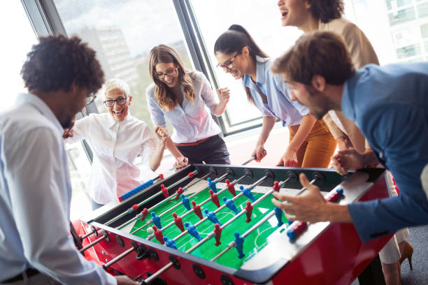 istock Employees playing table soccer indoor game in the office during break time 1094815212