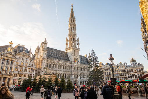 Nice December day in Brussels, tourists walking on the 'Grand Place'. The Maison du Roi King's House or Breadhouse on the left.