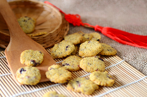 Chinese new year homemade cookies with cranberry on bamboo stick , on sackcloth background