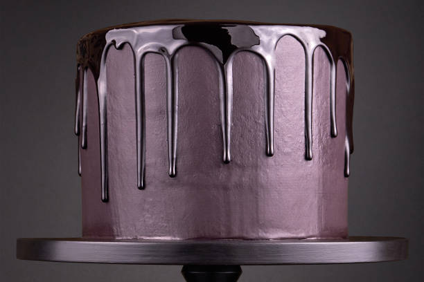 istock Chocolate cake with black glaze on a black background. 1094819948
