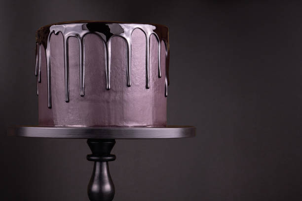 Chocolate cake with black glaze on a black background.