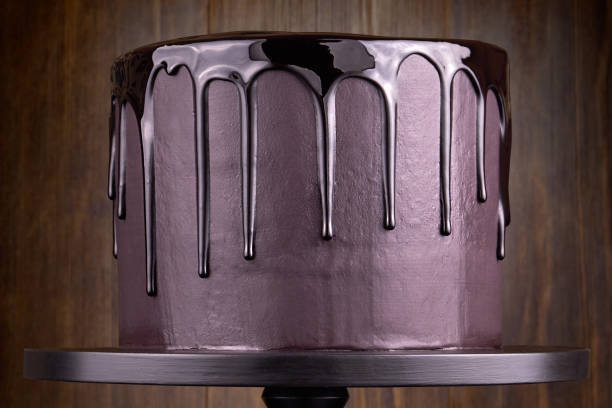 istock Chocolate cake with black glaze on a black wooden background. 1094819960