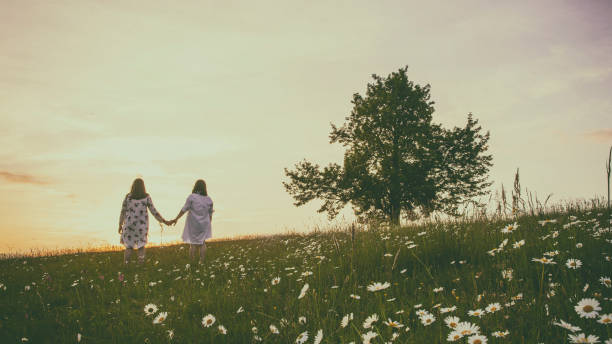 istock Two girls on meadow 1094820178