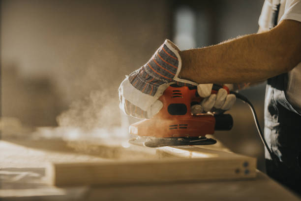istock Close up of  unrecognizable manual worker working with sander on a wood plank. 1094822356