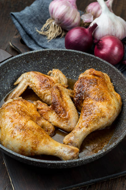 istock Grilled chicken legs with spices, onion and garlic. 1094823258