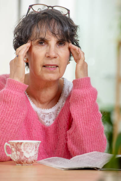 istock senior woman with eyes ache 1094824120