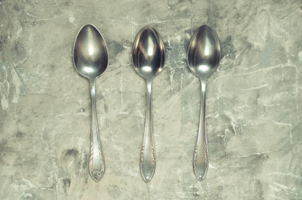 istock Vintage steel spoons on a gray concrete background. Top View 1094824146