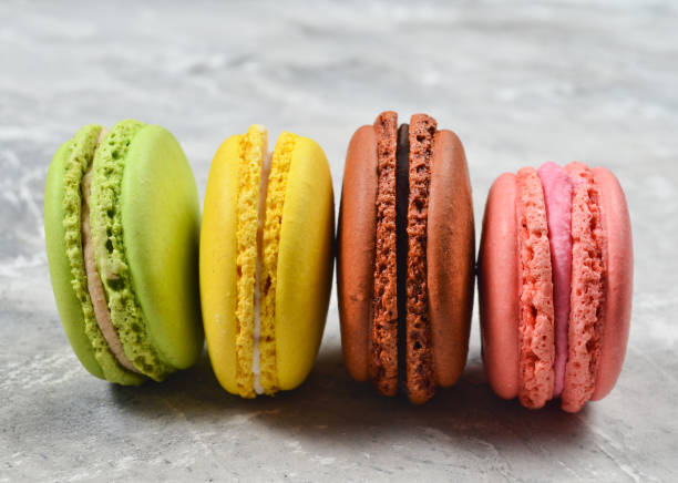 istock Colored pastel macaroons on a gray concrete background 1094824152
