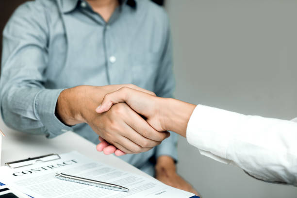 istock Confident partnerships people shaking hands with making a contract in the office. 1094824330