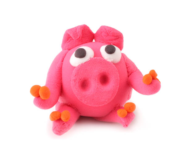 istock Kids modelling clay pig isolated on white background 1094825490