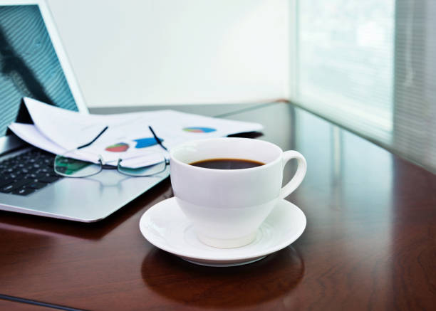 istock Coffee cup and office supplies on table 1094827364