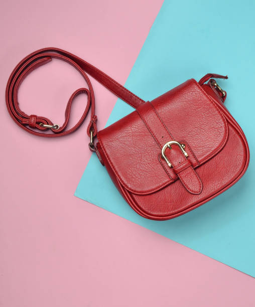 istock Red leather bag on a colored pastel background. Minimalism, top view 1094829766
