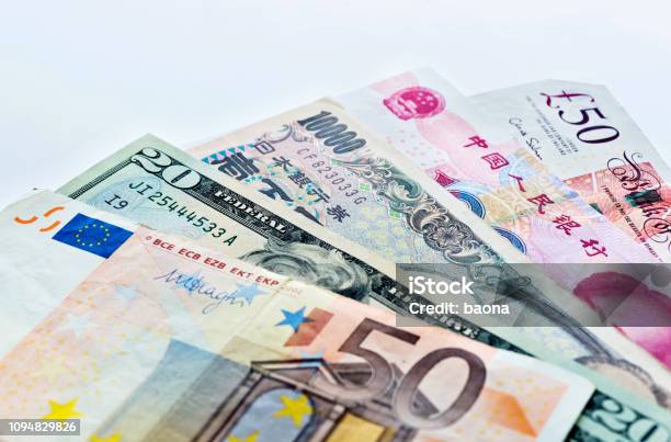 International Currency Notes On White Background Stock Photo - Download Image Now - Currency Exchange, Exchange Rate, Travel