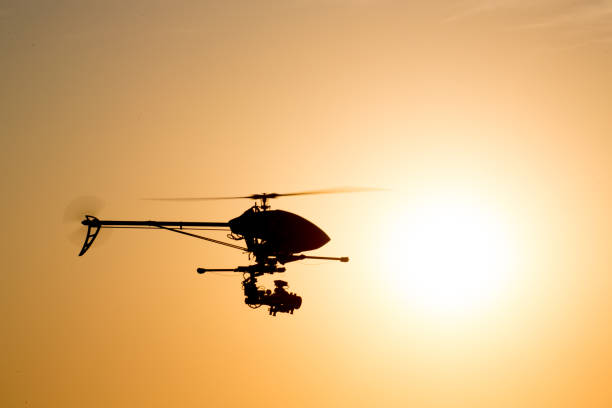 istock Helicopter camera drone silhouetted against the late afternoon sun 1094829986