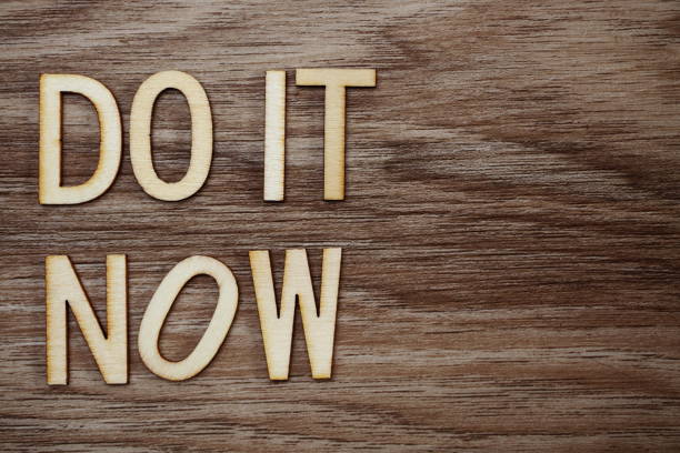 istock Do It Now on wooden background business concept 1094832080