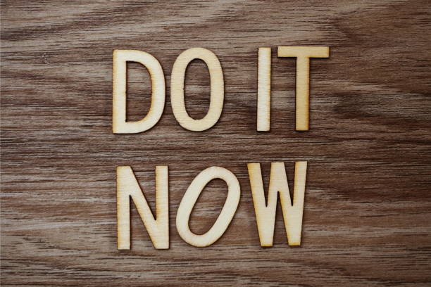 istock Do It Now on wooden background business concept 1094832162