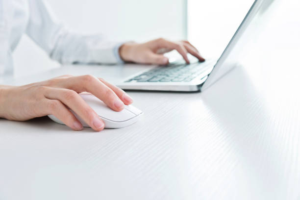 Businesswoman hands on a mouse and keyboard