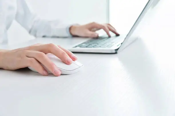 Photo of Businesswoman hands on a mouse and keyboard