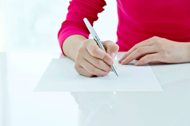 istock Woman writing on a paper 1094837700