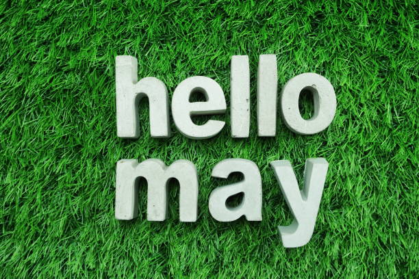 hello may made from concrete alphabet top view on green grass - may imagens e fotografias de stock