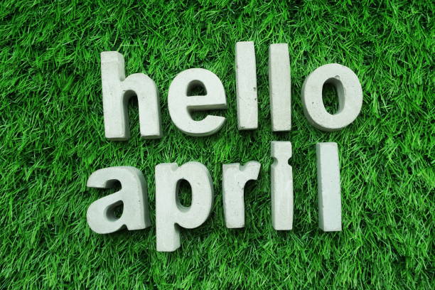 istock Hello April made from concrete alphabet top view on green grass 1094838598