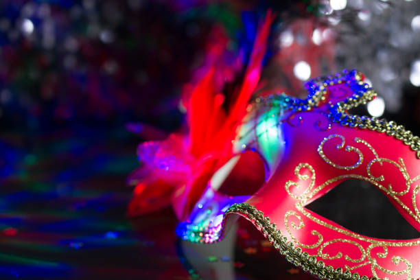 istock Venetian red mask on defocused carnival party background 1094841072