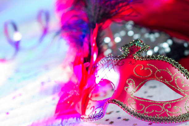 istock Venetian red mask on defocused carnival party background 1094841112