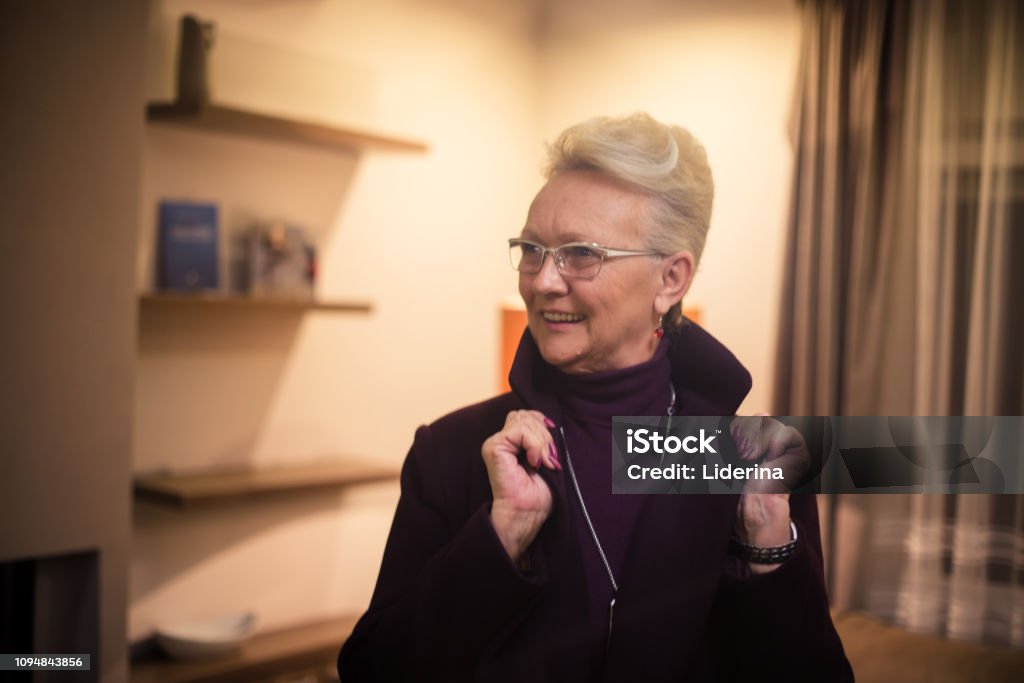 You're never old to look fatal. You're never old to look fatal. Senior woman at home. Adult Stock Photo