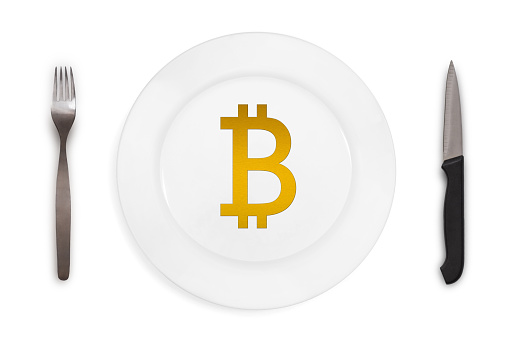 icon of virtual electronic gold money of bitcoin served on white empty plate. Concept. Isolated