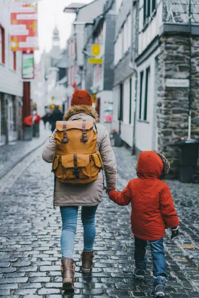 Mother with little son  walking in old town in Monschau