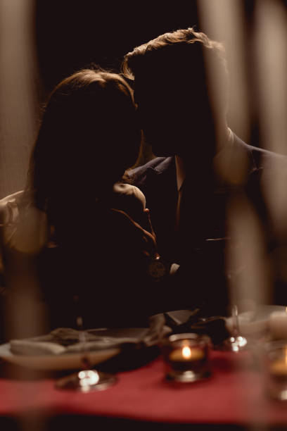 istock silhouette of couple during romantic date in restaurant 1094847146
