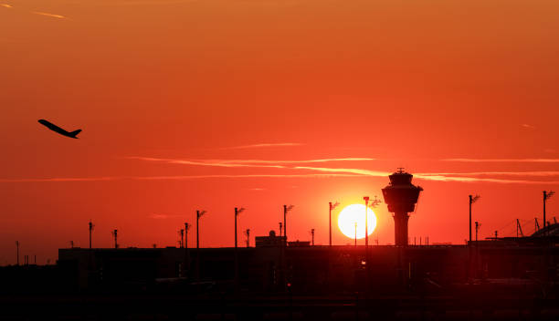 istock Airport control tower and airplane during sunset. 1094849276