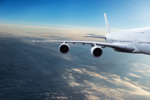 istock Huge two-storey passengers commercial airplane flying above dramatic clouds, sunset. 1094849942