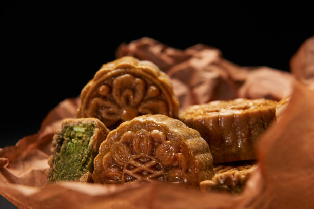 istock selective focus of traditional chinese mooncakes isolated on black 1094850788