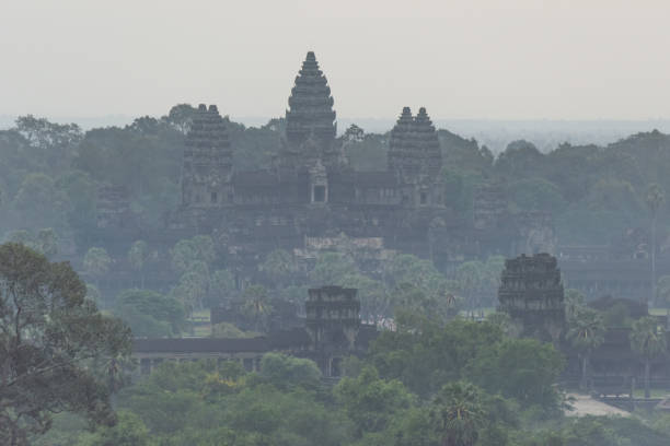 istock Misty ruins of Angkor Wat among trees 1094851344