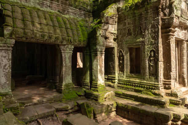 istock Moss-covered columns and statues by temple doorway 1094851440