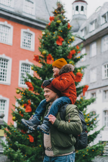istock Father with son standing near the Christmas tree 1094851532