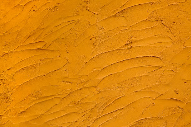 istock Colorful patterns and surfaces of yellow cement wall. 1094854058
