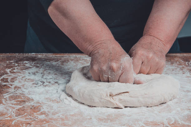 istock An old woman's grandmother is kneading a dough for cooking bread 1094855076