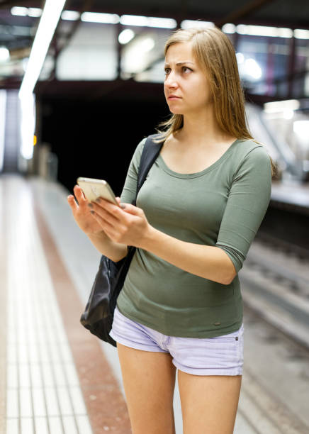 istock Woman is standing on platform and waiting train 1094865732