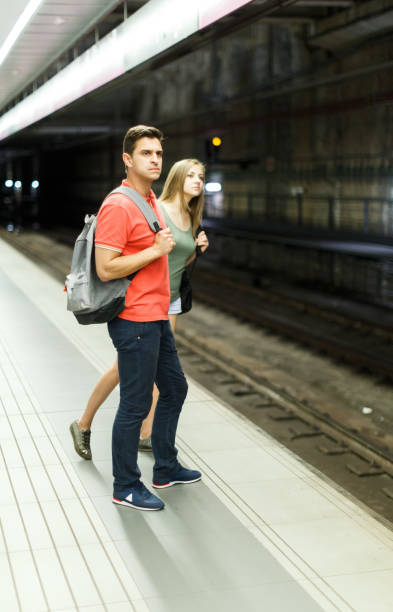 istock Man with his girlfriend are standing on platform and waiting train 1094865746