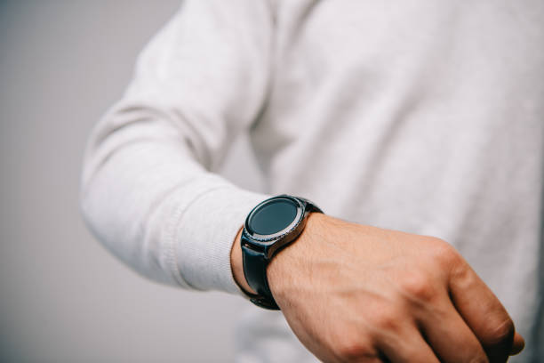 istock partial view of man with wristwatch on hand isolated on grey 1094866080