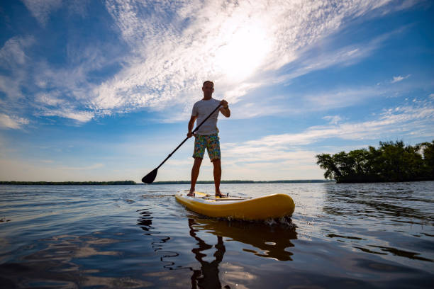 istock Happy man is paddling on a SUP board 1094866982