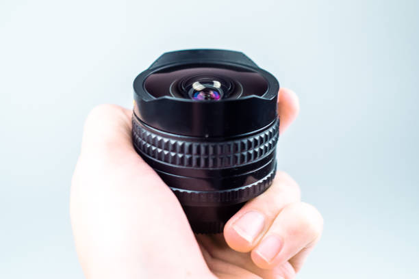 istock Old lens in hands on a white background 1094867274