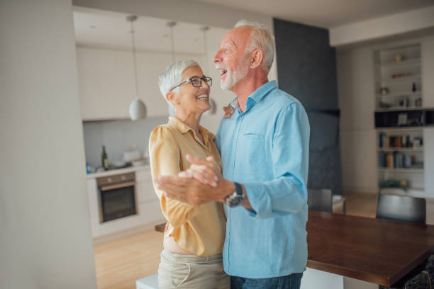 istock Senior couple dancing at home 1094867456